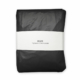 Black rain poncho packed small, Recycled Rain Poncho REZO black, packaged in the recycled band